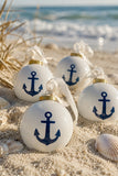 Anchor ceramic ball ornament with navy anchor motif on beach