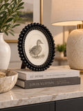 Black Oval Beaded Photo Frame styled in a modern interior
