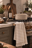 Earth Tone Stripe Towel styled on a range in a warm neutral kitchen