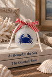 Frosted glass navy crab holiday ornament with gingham ribbon and off-white nautical twisted cotton rope