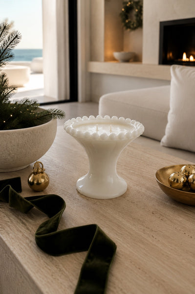 Beaded milk glass pedestal three-wick soy candle styled in a refined coastal interior