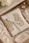Amélie handcrafted ivory crochet lingerie bag with champagne floral lace appliqués and ivory velvet ribbon in a luxe drawer