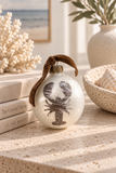 Hand-faded pearlescent lobster glass ornament with brown velvet ribbon