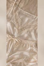 Close-up of Mayenne Nuit V-neck French lace, silk shorts hem and satin woven label