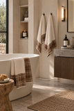 Mayenne Maison Plaid Trim Bath and Hand Towel Set styled in a modern neutral bathroom