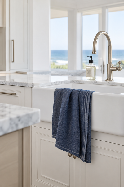 Stone-washed soft indigo dish towel staged in a modern beach house kitchen