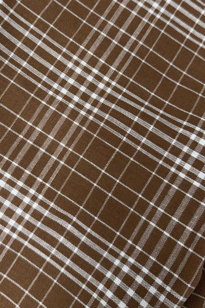 Close-up of tobacco plaid napkin fabric weave and pattern