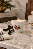 Vintage poinsettia porcelain teacup candle with green velvet ribbon and brass bell
