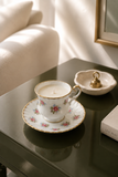 Vintage floral china teacup and saucer soy candle styled in a refined interior